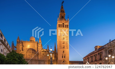 La Giralda and Seville Cathedral day to night timelapse glowing under the night sky. 124782047