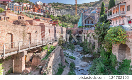 Abanotubani district in Old Tbilisi, Georgia where most of the Sulphur baths are located aerial timelapse. 124782103