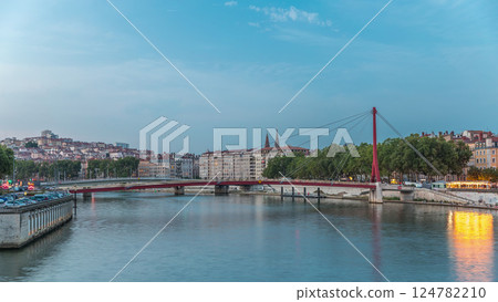 Hyperlapse of the Passerelle du Palais du Justice bridge over the Saone River in Lyon, transition from day to night timelapse. 124782210