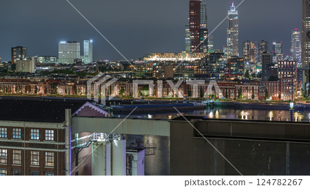 Panoramic night aerial timelapse of Katendrecht peninsula and Maashaven harbour in Rotterdam, The Netherlands. Panoramic night aerial timelapse of Katendrecht peninsula and Maashaven harbour in Rotterdam, The Netherlands. 124782267