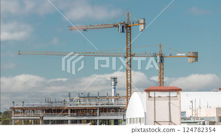 Timelapse of construction site with cranes working on a building complex. 124782354