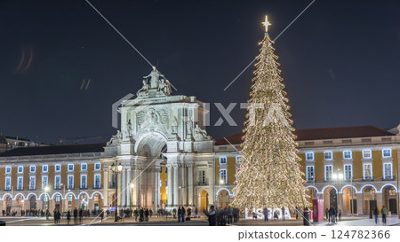 Commerce Square in Lisbon illuminated at Christmas hyperlapse, with a towering tree and crowds celebrating at night. Portugal 124782366