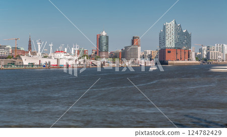 Timelapse of Hamburg's iconic Elbphilharmonie concert hall, with ships and boats in the foreground. Germany Timelapse of Hamburg's iconic Elbphilharmonie concert hall, with ships and boats in the foreground. Germany 124782429