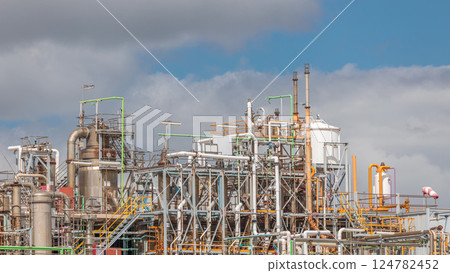 Distillation Columns and their process equipment of hydrogen plant timelapse with clouds on a background. 124782452