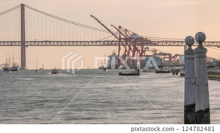 Cais das Colunas near Cais do Sodre timelapse with 25 April Bridge and cargo port terminal. Lisbon, Portugal 124782481