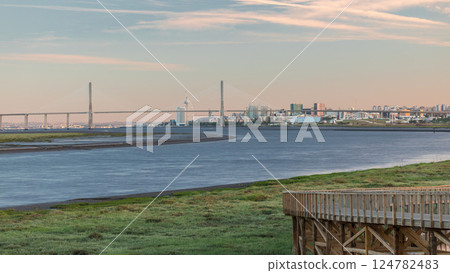 Vasco da Gama Bridge over river Tagus timelapse in Lisbon with park of Nations district modern architecture, Portugal 124782483