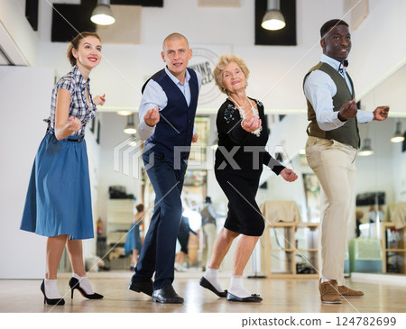 Group of different age dancers preparing swing performance Group of different age dancers preparing swing performance 124782699