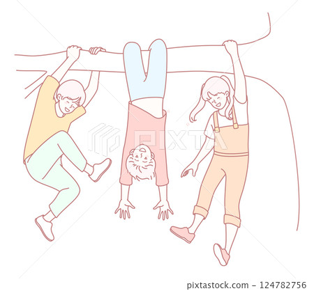 A group of playful children joyfully hanging from a strong tree branch in the sunshine 124782756