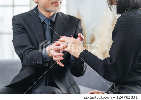 A middle-aged couple giving a ring as a gift 124782831