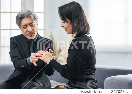 A middle-aged couple giving a ring as a gift A middle-aged couple giving a ring as a gift 124782832