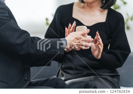 A middle-aged couple giving a ring as a gift 124782834