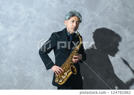 Middle-aged man playing the saxophone 124782862