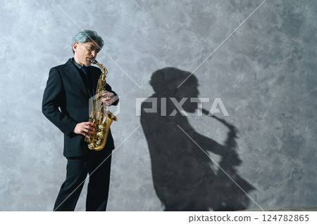 Middle-aged man playing the saxophone 124782865