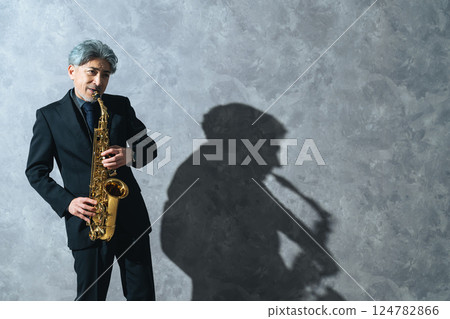 Middle-aged man playing the saxophone 124782866