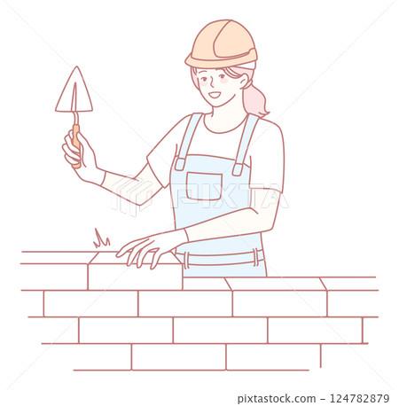 A skilled female mason worker is expertly building a sturdy wall using a trowel tool 124782879