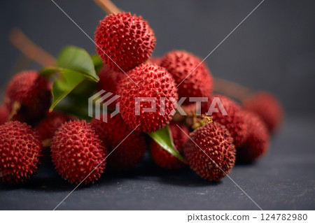 Fresh red lychee fruits with leaves Fresh red lychee fruits with leaves 124782980
