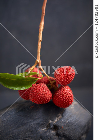 Fresh red lychee fruits with leaves Fresh red lychee fruits with leaves 124782981