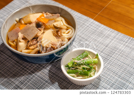 Japanese meal of meat udon with lots of ingredients and small side dishes Japanese meal of meat udon with lots of ingredients and small side dishes 124783303