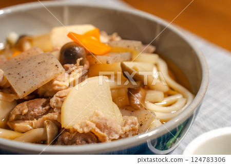 Japanese meal of meat udon with lots of ingredients and small side dishes Japanese meal of meat udon with lots of ingredients and small side dishes 124783306