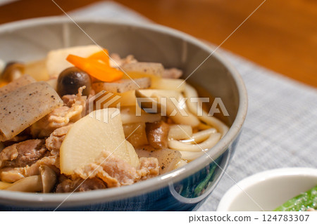 Japanese meal of meat udon with lots of ingredients and small side dishes 124783307