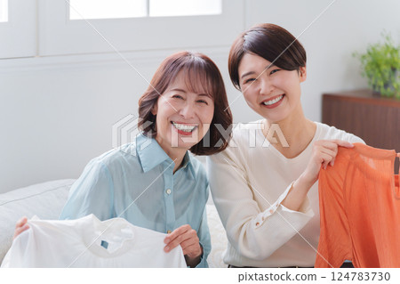 Parents and children buying clothes Parents and children buying clothes 124783730