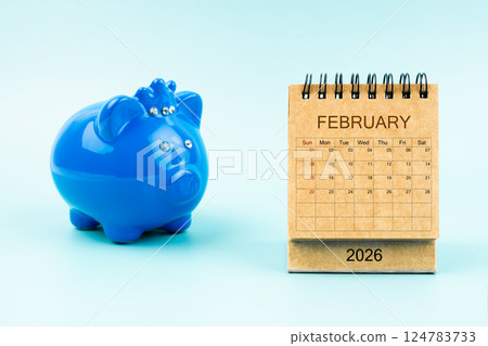 Blue piggy bank and blank February 2026 calendar, Reminder schedule of savings money. 124783733