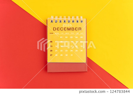 December 2026 desk calendar on red and yellow background. 124783844