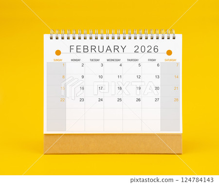 February 2026 desk calendar on yellow background, Front view. February 2026 desk calendar on yellow background, Front view. 124784143