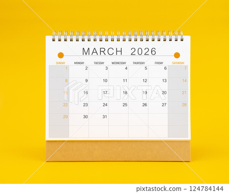 March 2026 desk calendar on yellow background, Front view. March 2026 desk calendar on yellow background, Front view. 124784144