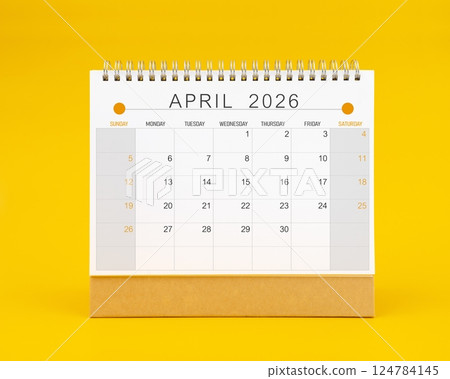 April 2026 desk calendar on yellow background, Front view. April 2026 desk calendar on yellow background, Front view. 124784145