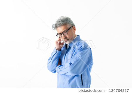 A man wearing work clothes A man wearing work clothes 124784257