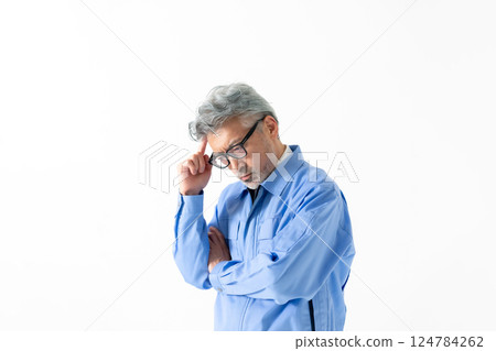A man wearing work clothes A man wearing work clothes 124784262