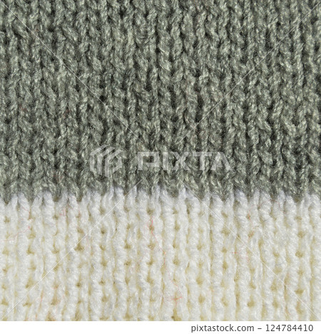 Handmade knitted fabric grey wool background texture, pattern fabric made of grey wool Handmade knitted fabric grey wool background texture, pattern fabric made of grey wool 124784410