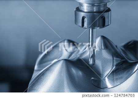 The CNC milling machine  finish cut the metal parts with ball nose end mill tools in the light blue scene. 124784703