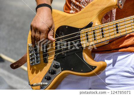 Playing an electric bass guitar Playing an electric bass guitar 124785071