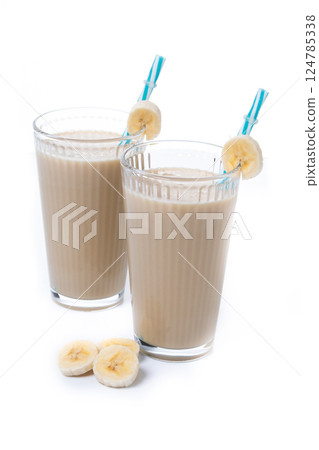Fresh and healthy banana smoothie in glass isolated on white background. Fresh and healthy banana smoothie in glass isolated on white background. 124785338