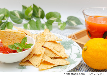 Corn tortilla chips, salsa sauce and vegetable juice 124785446