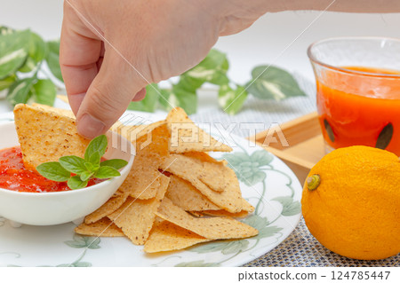 Corn tortilla chips, salsa sauce and vegetable juice 124785447