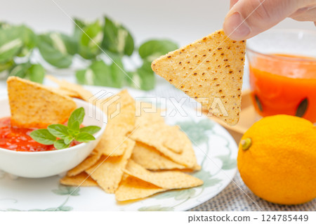 Corn tortilla chips, salsa sauce and vegetable juice Corn tortilla chips, salsa sauce and vegetable juice 124785449