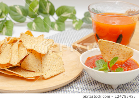 Corn tortilla chips, salsa sauce and vegetable juice 124785453