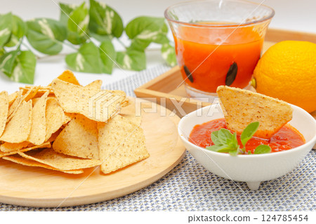Corn tortilla chips, salsa sauce and vegetable juice 124785454