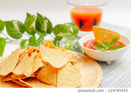 Corn tortilla chips, salsa sauce and vegetable juice 124785455