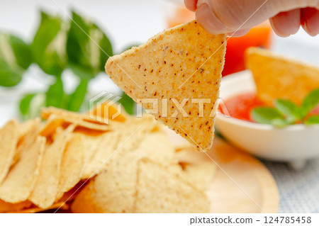 Corn tortilla chips, salsa sauce and vegetable juice 124785458