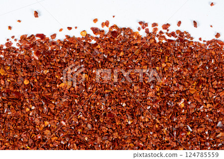Crushed red hot chili pepper natural seasoning, white background 124785559