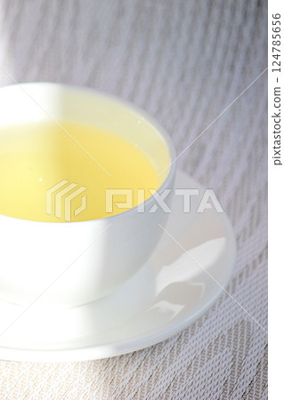 White cup and saucer with mint tea 124785656
