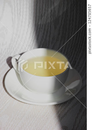 White cup and saucer with mint tea 124785657