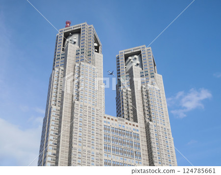 Tokyo Metropolitan Government Building and airplanes against the blue sky 124785661