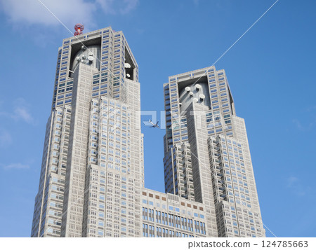 Tokyo Metropolitan Government Building and airplanes against the blue sky 124785663