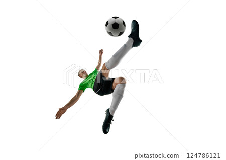 Low angle of strong man, dressed sport uniform, soccer player leaping for bicycle kick against white studio background. 124786121