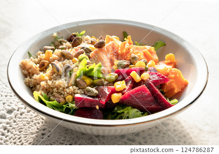 Delicious Quinoa Salmon Poke bowl garnished with Leaves salad, Beetroot, Sweet potato, Sweet corn and Pistachio. Delicious Quinoa Salmon Poke bowl garnished with Leaves salad, Beetroot, Sweet potato, Sweet corn and Pistachio. 124786287